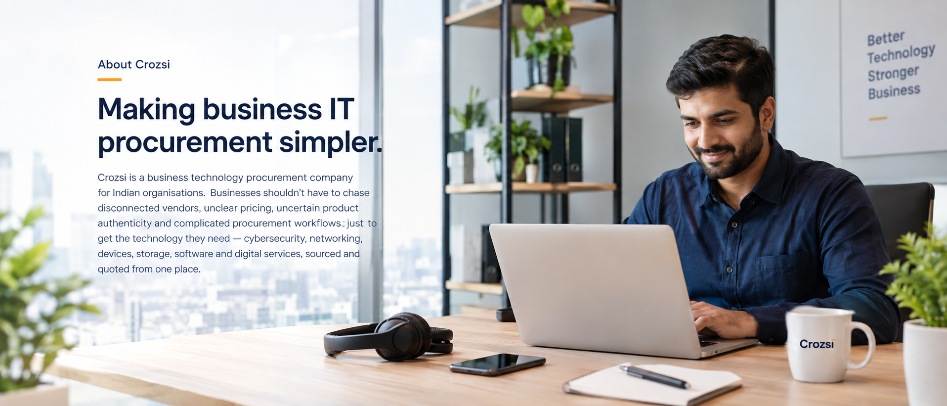 A business buyer at a desk with a laptop, headset and phone
